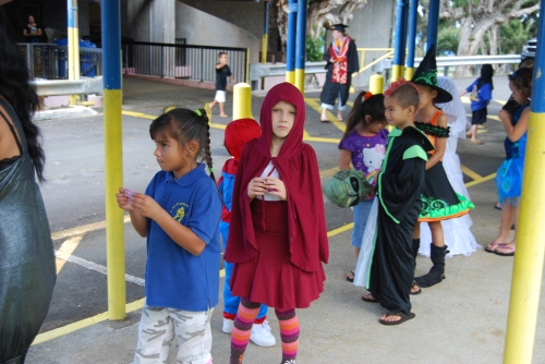 Little Red Riding Hood in the school Halloween parade in a sea of store bought costumes.